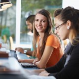 femalecollegestudentsittinginlibrary_64782778